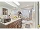 Bathroom with vanity, toilet, tub and shower, showcasing its functionality and design at 8907 Pandora Ln, Port Richey, FL 34668
