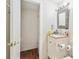 Bright bathroom with storage closet, classic vanity, and decorative mirror at 8907 Pandora Ln, Port Richey, FL 34668