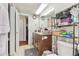 Bathroom with vanity, toilet, and storage shelves, showcasing functionality and organization at 8907 Pandora Ln, Port Richey, FL 34668