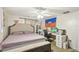A bedroom featuring a bed, desk with computer, and a Haitian flag on the wall at 8907 Pandora Ln, Port Richey, FL 34668