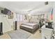 A bedroom with a bed, a ceiling fan, decor on the walls, and a tower fan at 8907 Pandora Ln, Port Richey, FL 34668