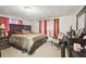 A bedroom featuring a large, dark wood bed frame with a light-colored carpet and curtains at 8907 Pandora Ln, Port Richey, FL 34668