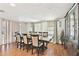 Bright dining room with a large table set for a dinner party and decorative cabinet at 8907 Pandora Ln, Port Richey, FL 34668