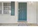Close-up view of the front door and adjacent window, showcasing the inviting entrance of the home at 8907 Pandora Ln, Port Richey, FL 34668