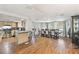A kitchen, dining, and living room open floor plan featuring hardwood floors at 8907 Pandora Ln, Port Richey, FL 34668