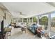 Enclosed sunroom with ample natural light and views of the backyard at 8907 Pandora Ln, Port Richey, FL 34668
