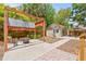 Well-manicured backyard with a pergola-covered seating area, fire pit, and a small shed at 906 E Broad St, Tampa, FL 33604