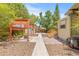 Charming backyard featuring a pergola, fire pit, and landscaped area, perfect for outdoor entertaining at 906 E Broad St, Tampa, FL 33604
