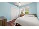 Bright bedroom with hardwood floors, closet, and natural light at 906 E Broad St, Tampa, FL 33604