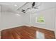Bedroom with hardwood floors, recessed lights, and a window providing natural light and outside views at 906 E Broad St, Tampa, FL 33604