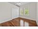 Bedroom showcasing hardwood floors, a double-door closet, and natural light from a window at 906 E Broad St, Tampa, FL 33604