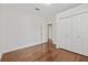 Bedroom offers hardwood floors, a closet, and a door to the hallway at 906 E Broad St, Tampa, FL 33604