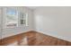 Bedroom with hardwood floors, white walls, trim and a double window for natural light at 906 E Broad St, Tampa, FL 33604