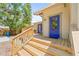 Inviting home exterior featuring a wooden deck and a bright blue front door at 906 E Broad St, Tampa, FL 33604