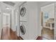Hallway with washer and dryer and bathroom entrance, leading to other areas of the home at 906 E Broad St, Tampa, FL 33604