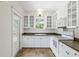Clean kitchen features white cabinets, contrasting countertops, tile floor, and stainless-steel appliances at 906 E Broad St, Tampa, FL 33604
