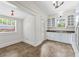 Bright kitchen with white cabinets, stainless steel appliances, and an adjoining room at 906 E Broad St, Tampa, FL 33604