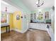 Bright eat-in kitchen features white cabinets, modern appliances, and sun-filled windows at 906 E Broad St, Tampa, FL 33604