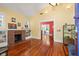 Cozy living room featuring a brick fireplace and gleaming hardwood floors at 906 E Broad St, Tampa, FL 33604