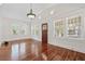 Bright living room boasts hardwood floors, chandelier, and natural light from multiple windows at 906 E Broad St, Tampa, FL 33604