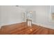Living room showcases hardwood floors, white trim, and glass panel french doors at 906 E Broad St, Tampa, FL 33604