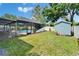 Lush green backyard features a screened pool, shed, and well-maintained lawn at 9410 Alanbrooke St, Temple Terrace, FL 33637