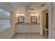 Bright bathroom featuring double sinks with granite counters and tile flooring at 9410 Alanbrooke St, Temple Terrace, FL 33637