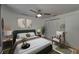 Cozy bedroom featuring decorative artwork, a ceiling fan, and a comfortable chair at 9410 Alanbrooke St, Temple Terrace, FL 33637
