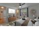 Airy bedroom with a ceiling fan, a window, and a view into an ensuite bath at 9410 Alanbrooke St, Temple Terrace, FL 33637