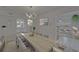 Formal dining room has neutral decor, an elegant light fixture, and views to the living room at 9410 Alanbrooke St, Temple Terrace, FL 33637
