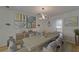Charming dining room with modern chandelier, built-in hutch, and doorway views to the kitchen at 9410 Alanbrooke St, Temple Terrace, FL 33637