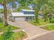 Charming two-story home with a two-car garage and a lush green lawn at 9410 Alanbrooke St, Temple Terrace, FL 33637