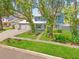 Charming two-story home with lush landscaping and a well-maintained front yard at 9410 Alanbrooke St, Temple Terrace, FL 33637
