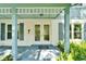 Inviting front porch with a double door entrance and tasteful blue accents at 9410 Alanbrooke St, Temple Terrace, FL 33637