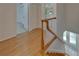 Bright hallway featuring wood flooring, a staircase, and white doors at 9410 Alanbrooke St, Temple Terrace, FL 33637