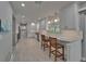 Modern kitchen featuring white cabinets, a breakfast bar, and updated appliances at 9410 Alanbrooke St, Temple Terrace, FL 33637