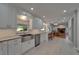 Open concept kitchen showcases white cabinets, granite countertops, stainless steel appliances, and breakfast bar at 9410 Alanbrooke St, Temple Terrace, FL 33637