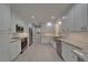 Spacious kitchen features white cabinets, stainless steel appliances, granite countertops, and tile flooring at 9410 Alanbrooke St, Temple Terrace, FL 33637