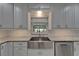Kitchen close-up highlights white cabinets, granite countertops, stainless steel appliances, and undermount sink at 9410 Alanbrooke St, Temple Terrace, FL 33637