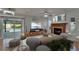 Cozy living area featuring a fireplace, a TV, and a view of the pool at 9410 Alanbrooke St, Temple Terrace, FL 33637