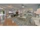 Spacious living room with neutral tones, ceiling fans, fireplace, and hardwood flooring at 9410 Alanbrooke St, Temple Terrace, FL 33637
