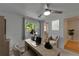 Inviting office space with a ceiling fan, natural light, and wainscotting at 9410 Alanbrooke St, Temple Terrace, FL 33637