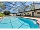 The screened-in pool area overlooks the home's backyard and features a spa and large outdoor area at 9410 Alanbrooke St, Temple Terrace, FL 33637