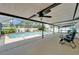 Screened-in pool area with a spacious patio, ceiling fan and inground pool and spa at 9410 Alanbrooke St, Temple Terrace, FL 33637