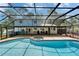This inground pool and spa are enclosed in a large, screened-in lanai, perfect for entertaining guests at 9410 Alanbrooke St, Temple Terrace, FL 33637