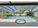 An inground pool and spa are enclosed in a screened in lanai with plenty of room for outdoor entertaining at 9410 Alanbrooke St, Temple Terrace, FL 33637