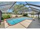 A screened-in inground pool features a spa and lots of space for outdoor entertaining in this backyard at 9410 Alanbrooke St, Temple Terrace, FL 33637