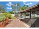 This property features a screened-in pool and lanai with lush landscaping and hardscapes surrounding it at 9410 Alanbrooke St, Temple Terrace, FL 33637