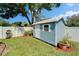 Charming backyard shed offers extra storage space and complements the landscaped yard at 9410 Alanbrooke St, Temple Terrace, FL 33637
