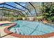 Sparkling swimming pool with a built-in spa and relaxing waterfall feature at 9410 Alanbrooke St, Temple Terrace, FL 33637